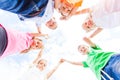 Lovely schoolchildren standing in a circle holding hands up Royalty Free Stock Photo