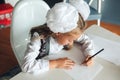 Lovely schoolgirl drawing good picture with colored pencils while sitting at table during art lesson at school. girl schoolgirl in Royalty Free Stock Photo