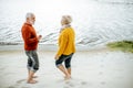 Senior couple in sweaters on the seashore Royalty Free Stock Photo