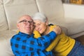 lovely senior couple hugging sitting at the sofa and thinking about past years medium shot seniority concept Royalty Free Stock Photo