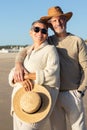 Lovely senior couple standing at seashore hugging and smiling Royalty Free Stock Photo