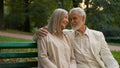 Lovely senior elderly happy Caucasian couple woman man embracing cuddle romantic date during retirement flirt Royalty Free Stock Photo