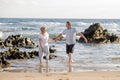 Lovely senior mature couple on their 60s or 70s retired walking happy and relaxed on beach sea shore in romantic aging together Royalty Free Stock Photo