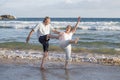 Lovely senior mature couple on their 60s or 70s retired walking happy and relaxed on beach sea shore in romantic aging together Royalty Free Stock Photo