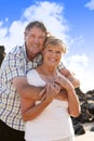 Lovely senior mature couple on their 60s or 70s retired walking happy and relaxed outdoors under a blue sky in love romantic aging