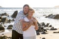 Lovely senior mature couple on their 60s or 70s retired walking happy and relaxed on beach sea shore in romantic aging together Royalty Free Stock Photo