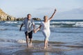 Lovely senior mature couple on their 60s or 70s retired walking happy and relaxed on beach sea shore in romantic aging together Royalty Free Stock Photo