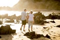 Lovely senior mature couple on their 60s or 70s retired walking happy and relaxed on beach sea shore in romantic aging together Royalty Free Stock Photo