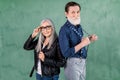 Lovely senior smiling joyful couple, handsome bearded man and pretty gray haired woman, posing to camera in front of Royalty Free Stock Photo