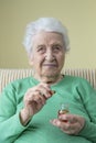 A lovely senior woman holding vitamin capsules Royalty Free Stock Photo