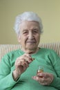 A lovely senior woman holding vitamin capsules Royalty Free Stock Photo