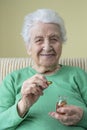 A lovely senior woman holding vitamin capsules Royalty Free Stock Photo