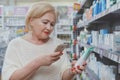 Lovely senior woman shopping at drugstore