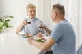 Lovely seniors couple enjoys eating healthy dinner together. Looking romantic at each other, drinks tea Royalty Free Stock Photo