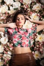 Lovely sensual woman lying on flowers
