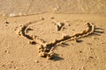 Lovely small heart sketched in salt sand at beach. Royalty Free Stock Photo