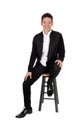 Lovely smiling teenager boy sitting on a chair Royalty Free Stock Photo