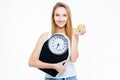 Lovely smiling young woman with fresh apple and scales Royalty Free Stock Photo