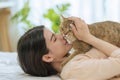 Young Asian Woman Kissing Cat in Bedroom Morning Royalty Free Stock Photo