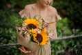 Lovely stylish bouquet with sunflowers in the hands woman