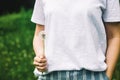 Lovely summer picture of a female hand holding dandelion against grass background Royalty Free Stock Photo