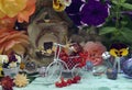 Lovely summer still life with funny snail, tiny bicycle, doll house, flowers and berries in the garden