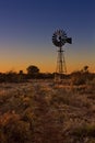 Lovely sunset in Kalahari with windmill and grass Royalty Free Stock Photo