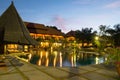 Lovely Sunset View at Pool Area with Nipa Hut Sunshade in a Tropical Beach Resort Royalty Free Stock Photo