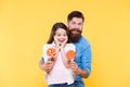 Lovely surprise. Girl cheerful child and dad hold colorful lollipops. Sweet dessert concept. Bearded hipster good daddy Royalty Free Stock Photo