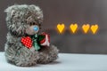 Lovely teddy bear with heart in hand