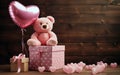 A lovely teddy bear with a heart-shaped baloon as a present for a beloved person Royalty Free Stock Photo