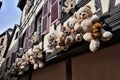 Lovely teddy bears hanging at a half-timbered house. Royalty Free Stock Photo