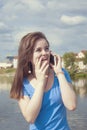 Lovely teen girl with enthusiasm talking on the phone and receiving joyful news and surprise. Royalty Free Stock Photo