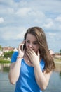 Lovely teen girl with enthusiasm talking on the phone and receiving surprise. Royalty Free Stock Photo