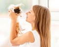 Young teen girl holding guinea pig on the floor Royalty Free Stock Photo