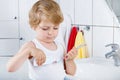 Lovely toddler boy brushing his teeth, indoors Royalty Free Stock Photo