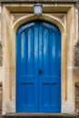 Blue Large Wooden Church Door With Stone Archway & Lantern On Top