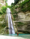 Lovely travel couple at Tropical Waterfall in the jungle in Dao Falls in Cebu Island, Philippines