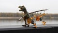 Lovely vintage yellow Baltic amber earrings hang from a twig held in the paws of a dinosaur.