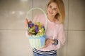 lovely wicker basket with orchids and blue muscari in hands of young woman florist
