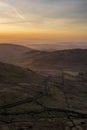 Lovely Winter landscape view from Red Screes across misty layers of mountains towards the East Royalty Free Stock Photo