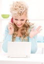 Lovely woman with cell phone and computer Royalty Free Stock Photo