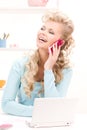 Lovely woman with cell phone and computer Royalty Free Stock Photo