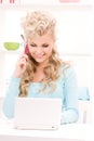 Lovely woman with cell phone and computer Royalty Free Stock Photo