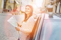 Lovely woman checking map during car stop Royalty Free Stock Photo