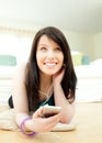 Lovely woman listening music lying on the floor Royalty Free Stock Photo