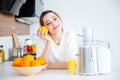 Lovely woman making orange juice on the kitchen Royalty Free Stock Photo