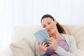 Lovely woman reading a romance sitting on the sofa Royalty Free Stock Photo