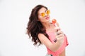 Lovely woman in sunglasses holding candy Royalty Free Stock Photo