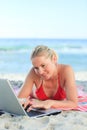 Lovely woman working on her laptop at the beach Royalty Free Stock Photo